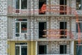 Facade of modern apartment house under construction with scaffolding Royalty Free Stock Photo