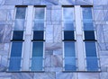 Facade of modern building with blue marble tiles and panes Royalty Free Stock Photo