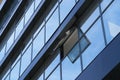 Facade of a modern building on a bright Sunny day, blue sky and clouds reflecting in a glass, beautiful exterior of the new Royalty Free Stock Photo