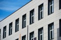 Facade of a modern building on a bright Sunny day, siding and Windows, beautiful exterior of the new building