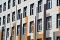 Facade of a modern building on a bright Sunny day, siding and Windows, beautiful exterior of the new building