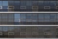 facade of modern building with detail horizontal outer louver and reflected glass windows. Royalty Free Stock Photo