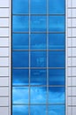 Facade of modern building. Reflection of blue sky in window Royalty Free Stock Photo