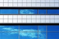 Facade of modern building. Reflection of sky and clouds in windows. Royalty Free Stock Photo