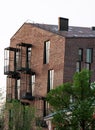 Facade of a modern city brick building. Texture materials. High windows and small balconies Royalty Free Stock Photo