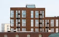 Facade of a modern city brick building. Texture materials. High windows and suspensions for air conditioner