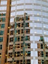 Facade of modern glass building with reflections of blue sky Royalty Free Stock Photo