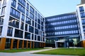 Facade of a modern office building and courtyard with sidewalk in new contemporary business center, no people Royalty Free Stock Photo