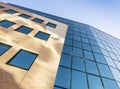 Facade of modern office building in glass and steel with reflections of blue sky Royalty Free Stock Photo