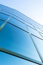 Facade of modern office building in glass and steel with reflections of blue sky Royalty Free Stock Photo