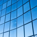 Facade of modern office building in glass and steel with reflections of blue sky Royalty Free Stock Photo