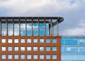 Facade of a modern office building. Square windows, attic floor and cloudy sky Royalty Free Stock Photo