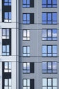 Facade of modern residential apartment building with reflection of cloudy blue sky in windows Royalty Free Stock Photo