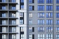 Facade of modern residential apartment building with reflection of cloudy blue sky in windows Royalty Free Stock Photo