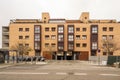 facade of a modern residential building built with light bricks and red metal framing Royalty Free Stock Photo