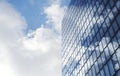 Facade of modern skyscraper with reflection of cloudy sky and a flock of birds, low angle shot, copy space Royalty Free Stock Photo