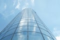 Facade of modern skyscraper with reflection of cloudy sky, low angle shot,copy space