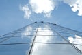 Facade of modern skyscraper with reflection of cloudy sky, low angle shot,copy space Royalty Free Stock Photo