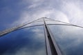 Facade of modern skyscraper with reflection of cloudy sky, low angle shot, free copy space Royalty Free Stock Photo