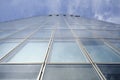 Facade of modern skyscraper with reflection of cloudy sky, low angle shot, free copy space Royalty Free Stock Photo