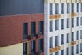 Facade of a modern two-tone multi-storey residential building with facade baskets or air conditioner boxes. Construction Royalty Free Stock Photo