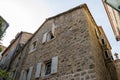 Facade of a multi-storey old stone house. Old Town of Budva. Montenegro Royalty Free Stock Photo
