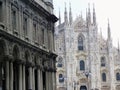 Facade of the neo-gothic cathedral of Milan with in front of a neoclassic building. Italy. Royalty Free Stock Photo