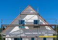 Facade of a new built house with scaffolding at the outisde