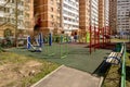 The facade of a new multi-storey apartment building and a children`s playground in Moscow