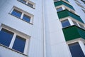 Facade of a new multi-storey building with white and green metal siding, many Windows Royalty Free Stock Photo