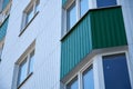 Facade of a new multi-storey building with white and green metal siding, many Windows Royalty Free Stock Photo