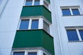 Facade of a new multi-storey building with white and green metal siding, many Windows Royalty Free Stock Photo