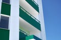 Facade of a new multistory building with white and green metal siding, many Windows Royalty Free Stock Photo