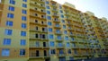 Facade of new residential building yellow and orange color. House Share. Real estate. Mortgage Interest Rates concept. Constructio