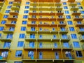 Facade of new yellow color residential building. Rising prices for purchase, sale and rental of real estate. Inexpensive Royalty Free Stock Photo