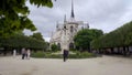 Facade of Notre-Dame Cathedral in Paris, people photographing near church