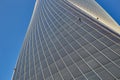 Facade of an office high-rise curved building. there are small black bulbs on the building, backlight. View from below. Royalty Free Stock Photo