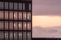 Facade of a office hogh rice with sunset clouds reflecting in the windows.. Royalty Free Stock Photo