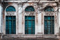 Facade of old abandoned building with large arched windows and columns Royalty Free Stock Photo