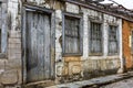 Facade of old abandoned house ruined by time