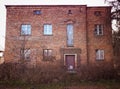 Old abandoned red brick house facade decay abstract