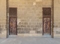 Old abandoned stone bricks wall with two weathered wooden doors Royalty Free Stock Photo