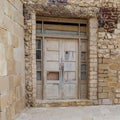 Old abandoned weathered wooden door and stone bricks wall Royalty Free Stock Photo