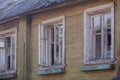 Facade of an old abandoned wooden house with broken windows Royalty Free Stock Photo