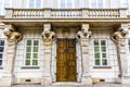 Facade of an old aparment building with a balcony with statues of four naked muscled men, Warsaw, Poland