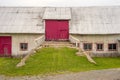 Facade of an old barn with red doors