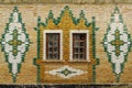 The facade of an old building is faced with glazed bricks. Steppe Zeikhgauz Royalty Free Stock Photo