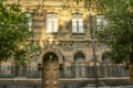 Facade of old building of multicolored tufa stone with carved arches Royalty Free Stock Photo