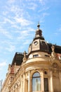 Facade of old building with sculptures against blue sky, low angle view Royalty Free Stock Photo