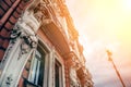 Facade of old building in St. Petersburg with statues of titans in sunshine